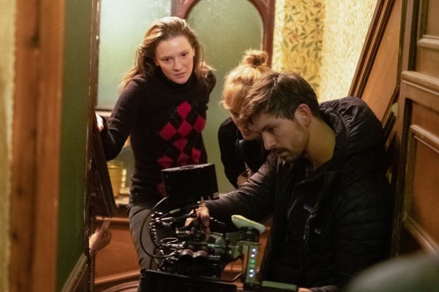 L to R: Morfydd Clark, Rose Glass, and Ben Fordesman on the set of SAINT MAUD. Cr: A24