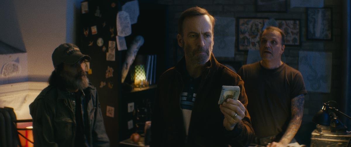 Stephen McIntyre as a U.S. Veteran, Bob Odenkirk as Hutch Mansell and Rick Dobran as a tattoo shop owner in “Nobody,” directed by Ilya Naishuller. Cr: Allen Fraser/Universal Pictures