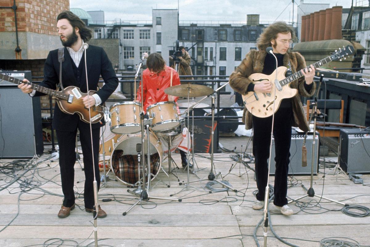 The Beatles perform their final concert on the roof of Apple headquarters. “The Beatles: Get Back.” Cr: Apple Corps Ltd./Disney