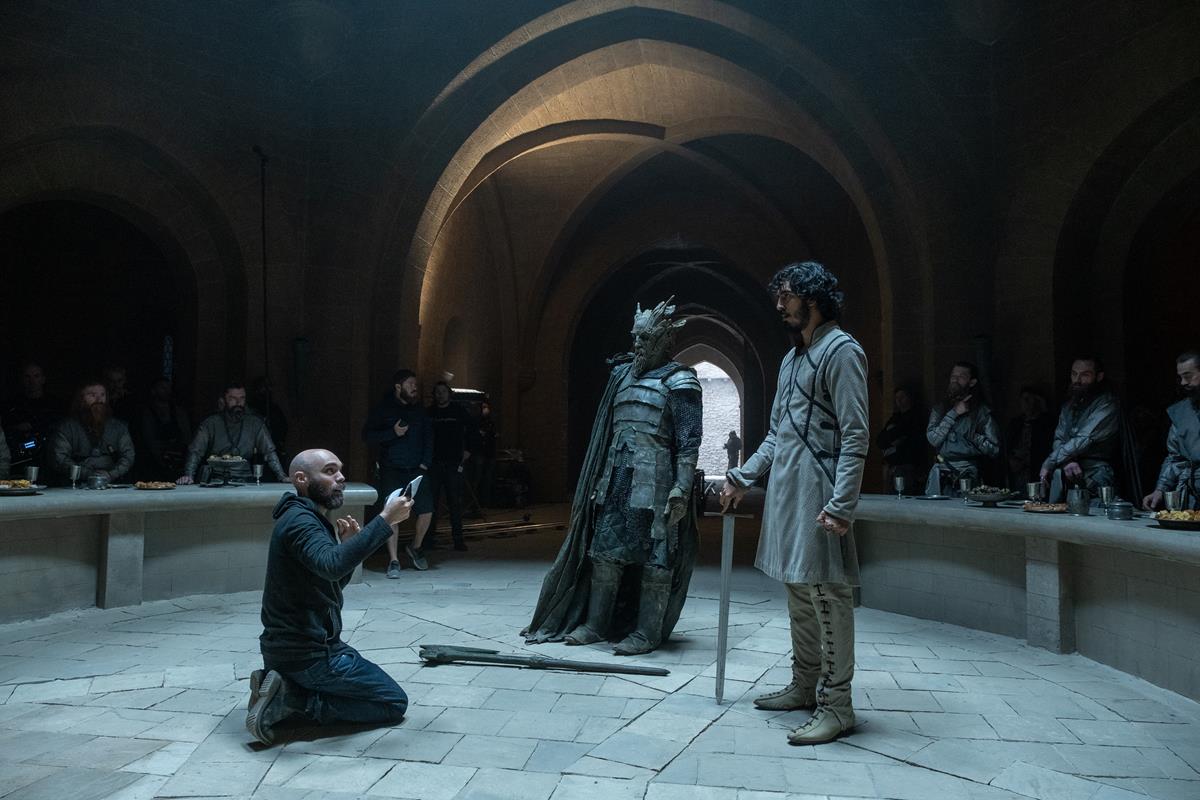 David Lowery, Ralph Ineson and Dev Patel on the set of “The Green Knight.” Cr: Eric Zachanowich/A24